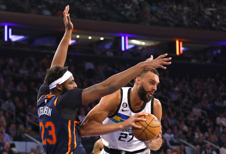 New York Knicks center Mitchell Robinson (23) defends against Minnesota Timberwolves center Rudy Gobert (27) during the first half of an NBA basketball game, Monday, March 20, 2023, in New York. (AP Photo/Noah K. Murray)
