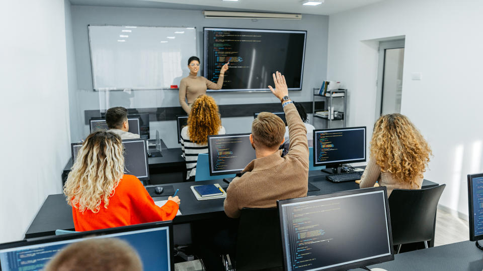 People learning to code in a classroom