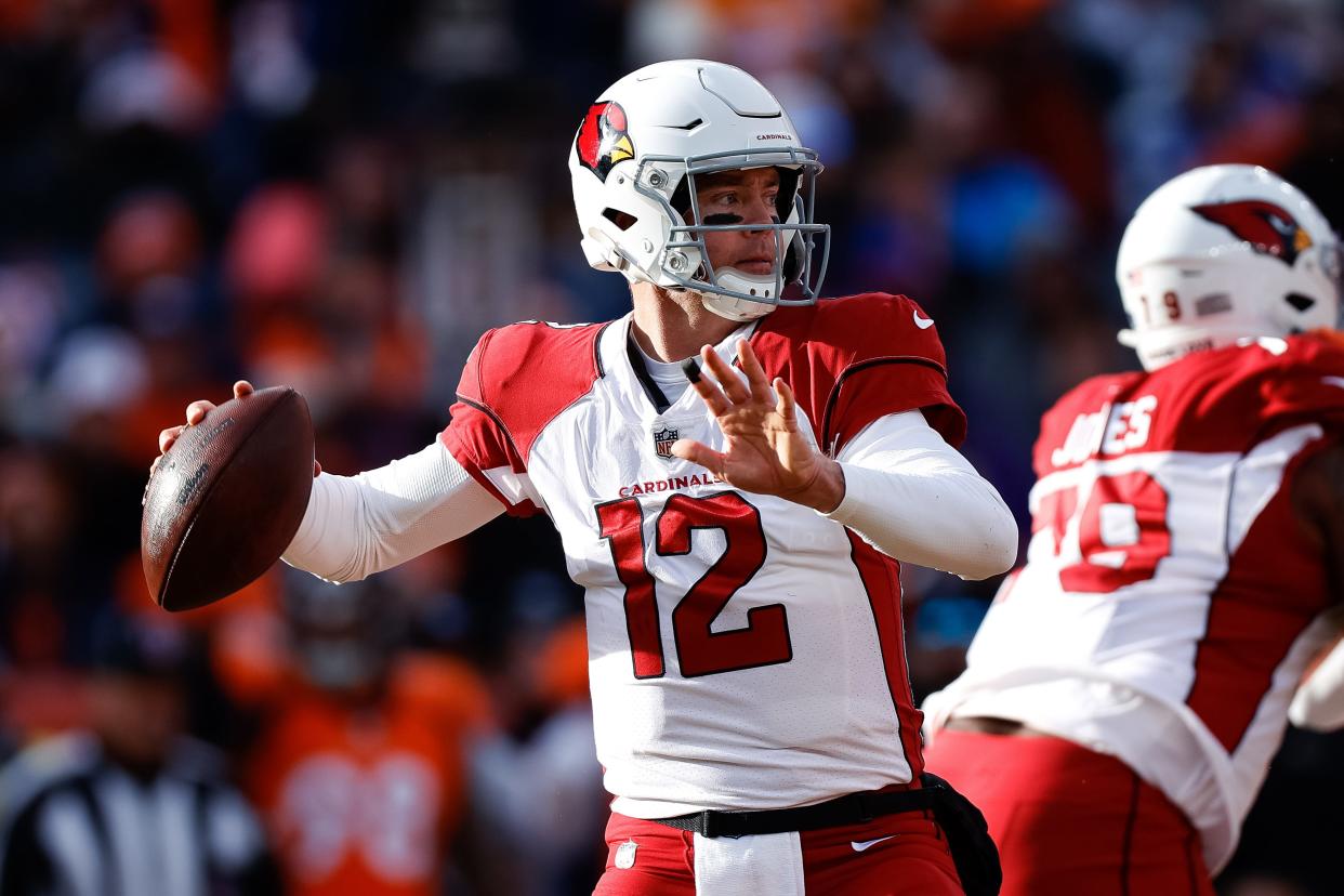 Dec 18, 2022; Denver, Colorado, USA; Arizona Cardinals quarterback Colt McCoy (12) looks to pass in the first quarter against the Denver Broncos at Empower Field at Mile High.