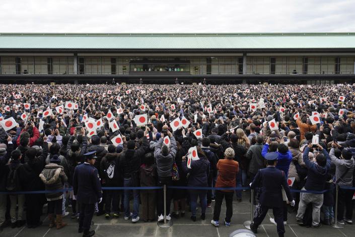 Well-wishers wave Japanese flags as Emperor Naruhito with his imperial families makes a public appearance at the bullet-proofed balcony of Imperial Palace in Tokyo Thursday, Jan. 2, 2020, in Tokyo. (AP Photo/Eugene Hoshiko)