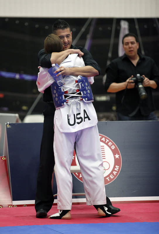 Diana Lopez gets a hug from her coach and older brother Jean Lopez after defeating Danielle Holmquist in the 2012 Taekwondo Olympic Trials at the U.S. Olympic Training Center on March 10, 2012 in Colorado Springs, Colorado. Lopez won the match 3-1. (Photo by Marc Piscotty/Getty Images)