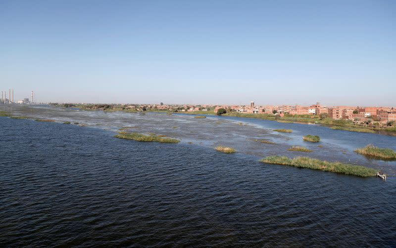 FILE PHOTO: Fishermen travel on a boat during low tide on the Nile River at Shoubra El-Kheima neighborhood in Cairo