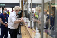 British Prime Minister Boris Johnson gives the thumbs up as he speaks to members of the staff during his visit to the Lordship Lane Primary care center where he met staff and people receiving their booster vaccines, in London, Tuesday, Nov. 30, 2021. (Paul Grover/Pool Photo via AP)