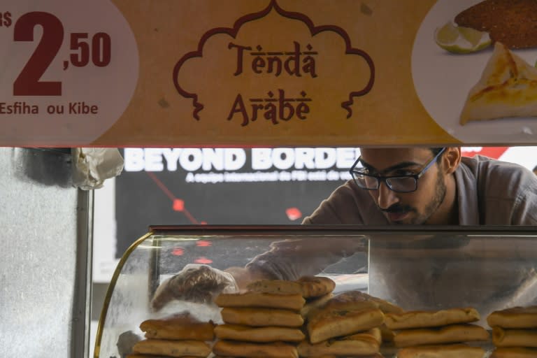 Egyptian immigrant Mohamed Ali Abdelmoatty Kenawy, who was attacked three weeks ago in what appeared to be a hate crime, works at his food stand in Rio's Copacabana neighborhood