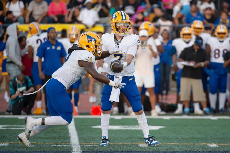 Grant Pacers quarterback Luke Alexander (7) hands off to Wayshawn Parker (1) at Oak Ridge High School.