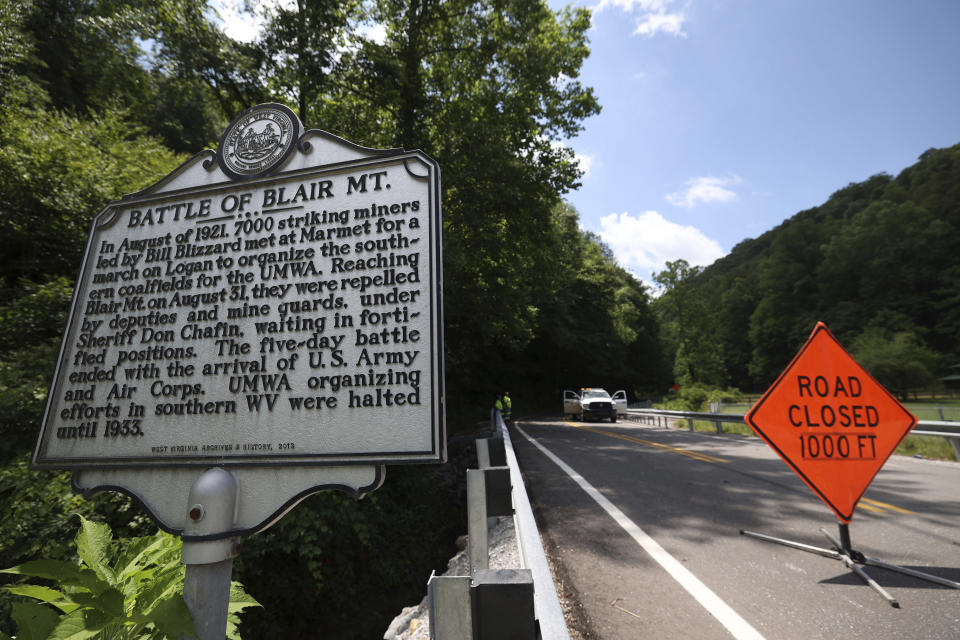 The road is closed after a helicopter crash in Blair, W.Va., on Thursday, June, 23, 2022. A Vietnam-era helicopter was used for tourism flights and crashed along Route 17 in Logan County about 5 p.m. Wednesday. County emergency ambulance service executive Ray Bryant says all six on board were killed.(AP Photo/Chris Jackson)