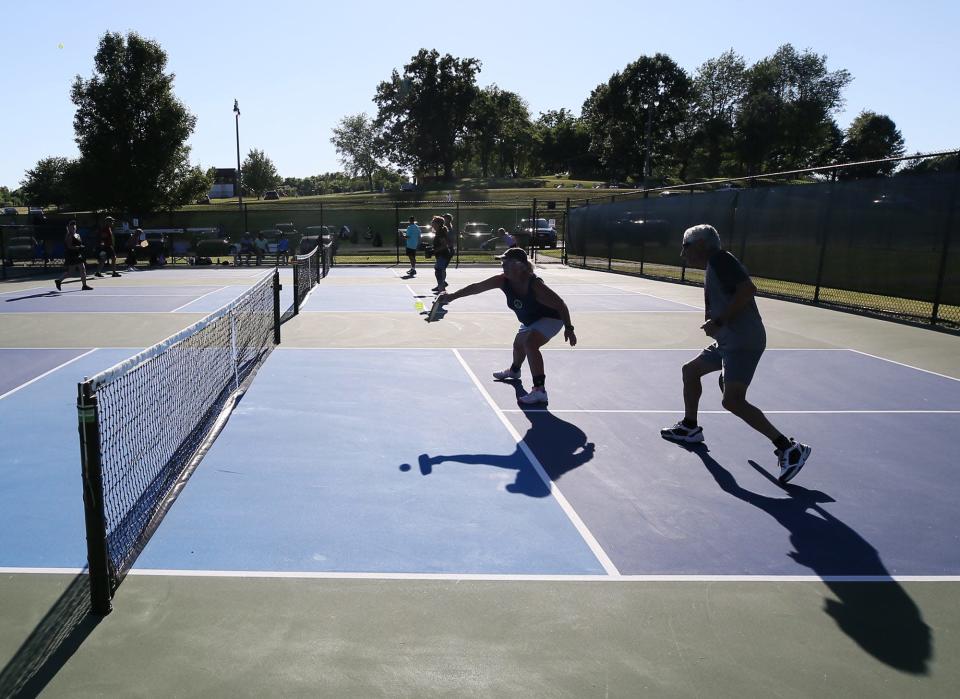 Rhonda Wells, 73, and Robert Keith, 75, play a doubles game at the Boettler Park pickleball courts in Green.