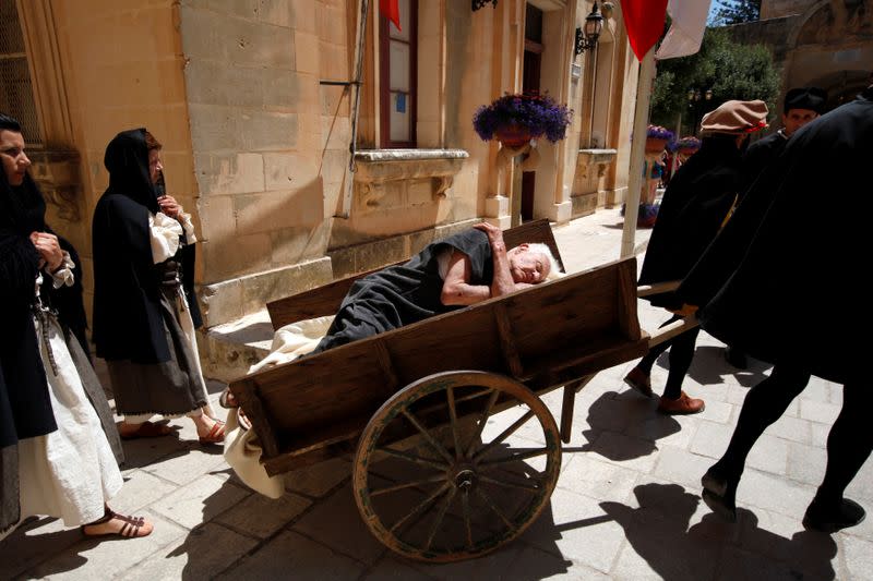 FILE PHOTO: Re-enactors recreate a scene showing a funeral during the Black Death plague during the Medieval Mdina Festival in Mdina