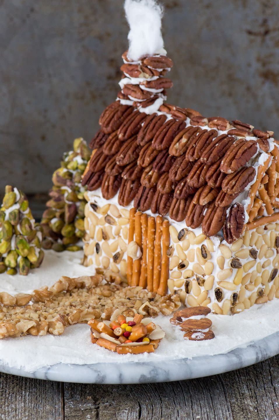 <p>If you're already dreading the post-creation sugar high, then use an assortment of nuts and salty snacks in place of candy.</p><p><em><a href="https://thefirstyearblog.com/nutty-gingerbread-house/" rel="nofollow noopener" target="_blank" data-ylk="slk:See more at The First Year Blog »;elm:context_link;itc:0;sec:content-canvas" class="link ">See more at The First Year Blog »</a></em></p>