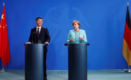German Chancellor Angela Merkel and Chinese President Xi Jinping attend a news conference at the Chancellery in Berlin, Germany, July 5, 2017. REUTERS/Fabrizio Bensch