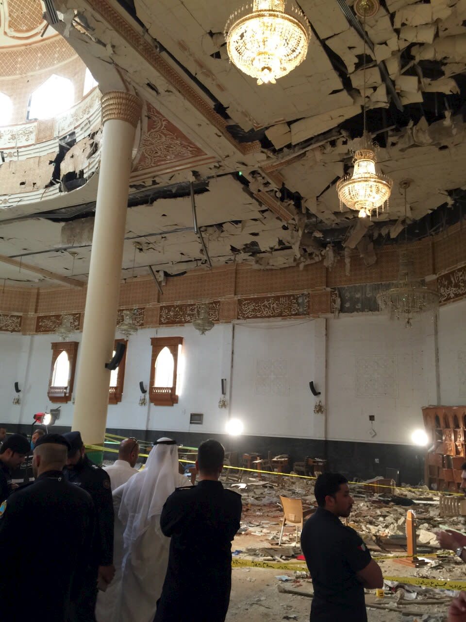 Police inspect the Imam Sadiq Mosque after a bomb explosion, in the Al Sawaber area of Kuwait City June 26, 2015. A suicide bomber blew himself up at the packed Shi'ite Muslim mosque in Kuwait city during Friday prayers, killing more than ten people, the governor of Kuwait City said. (REUTERS/Kuwait News Agency)