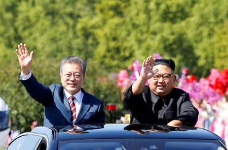 FILE PHOTO: South Korean President Moon Jae-in and North Korean leader Kim Jong Un wave during a car parade in Pyongyang, North Korea, September 18, 2018. Pyeongyang Press Corps/Pool via REUTERS/File Photo