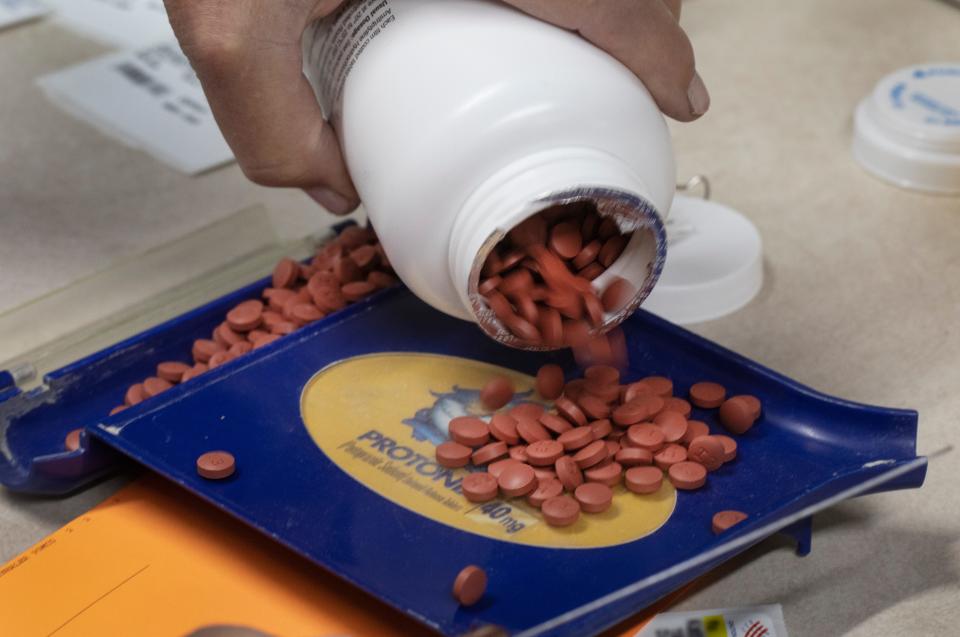 Carol Foltz prepares prescriptions at Faith Community Pharmacy in Newport on June 6, 2022.