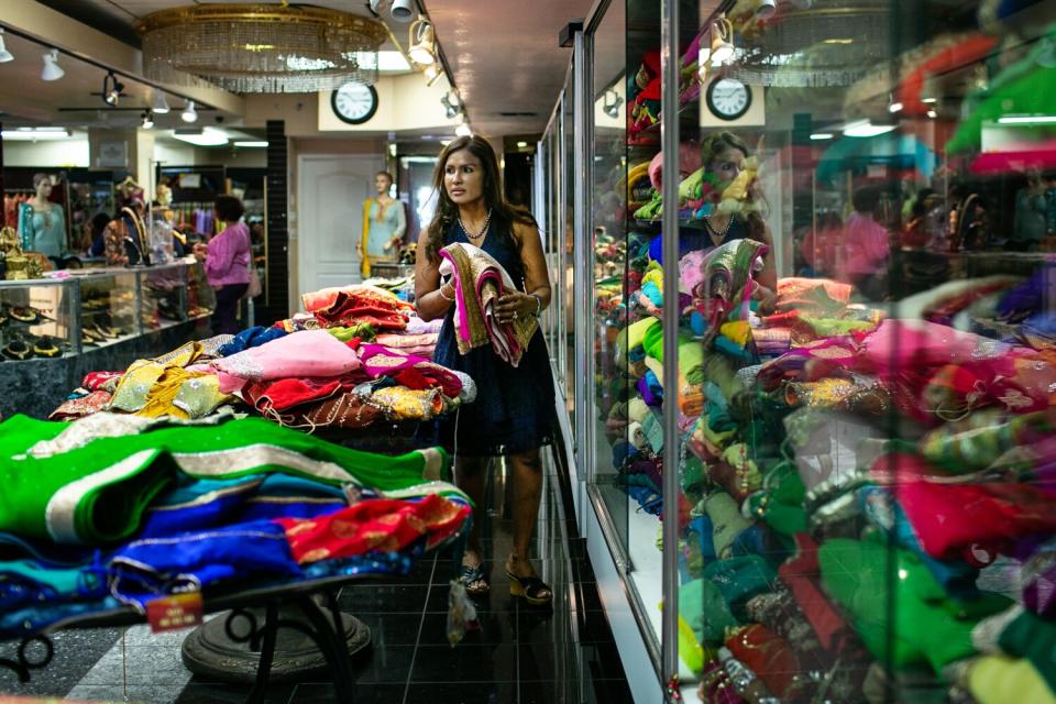 A woman walks in a clothing store