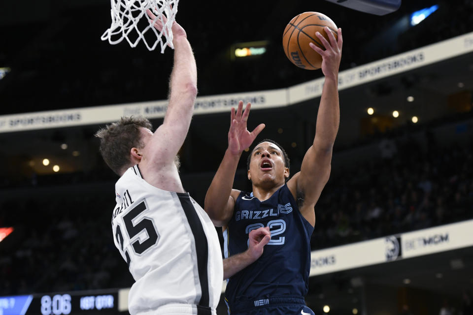 Memphis Grizzlies guard Desmond Bane (22) shoots against San Antonio Spurs center Jakob Poeltl (25) during the first half of an NBA basketball game Wednesday, Jan. 11, 2023, in Memphis, Tenn. (AP Photo/Brandon Dill)