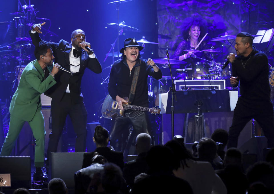 Miguel, from left, Wyclef Jean, Santana, and Andy Vargas perform on stage at the Pre-Grammy Gala And Salute To Industry Icons at the Beverly Hilton Hotel on Saturday, Jan. 25, 2020, in Beverly Hills, Calif. (Photo by Willy Sanjuan/Invision/AP)