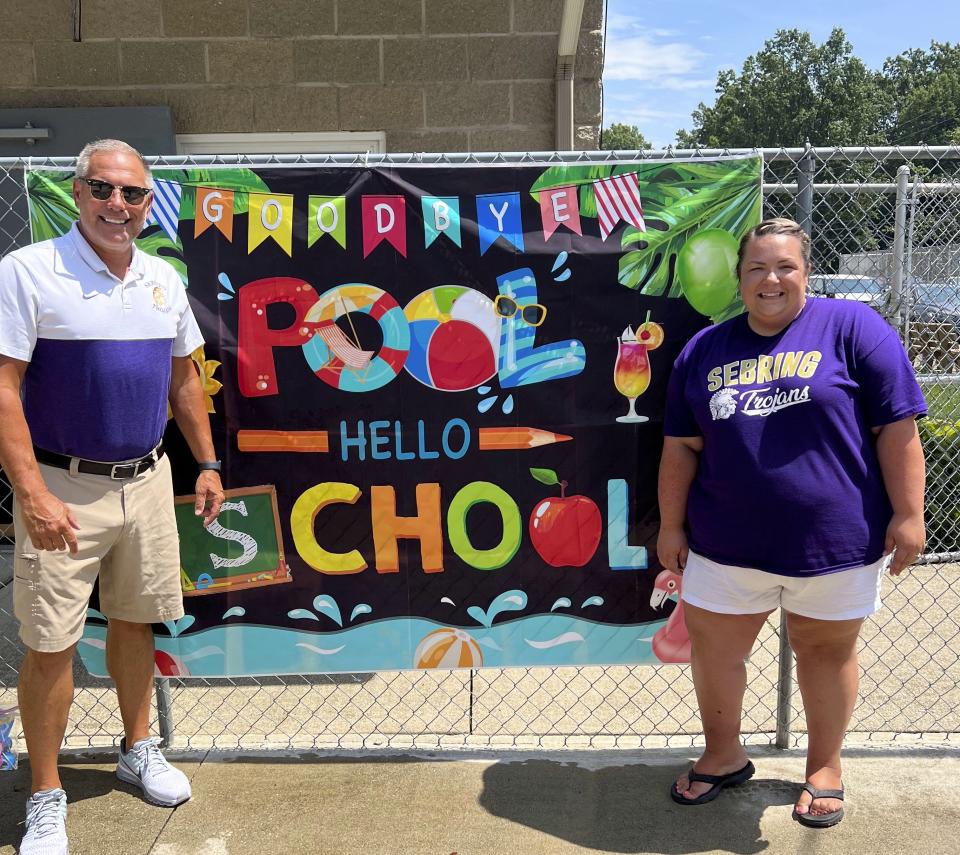 Brian Clark, left, principal of Sebring McKinley Jr/Sr High School, and Nichole Hanley, principal of B.L. Miller Elementary School, greeted students at the Back to School Bash on Sunday, Aug. 6, 2023, at Sebring Municipal Pool.