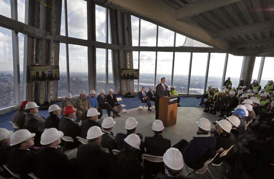 Legends Chairman & CEO David Checketts, at podium center, of the company that will run the observation deck on the 100th floor of the One World Trade Center building, address a news conference in the venue, in New York, Tuesday, April 2, 2013. The observation deck, that will not open until 2015, will occupy the tower's 100th through 102nd floors. Elevators will whisk visitors to the top in just one minute but the experience of visiting the attraction will take an hour. (AP Photo/Richard Drew)