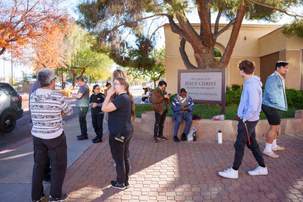 People wait on the outskirts of the UNLV campus after a shooting on 6 December 2023 in Las Vegas, Nevada (Getty Images)