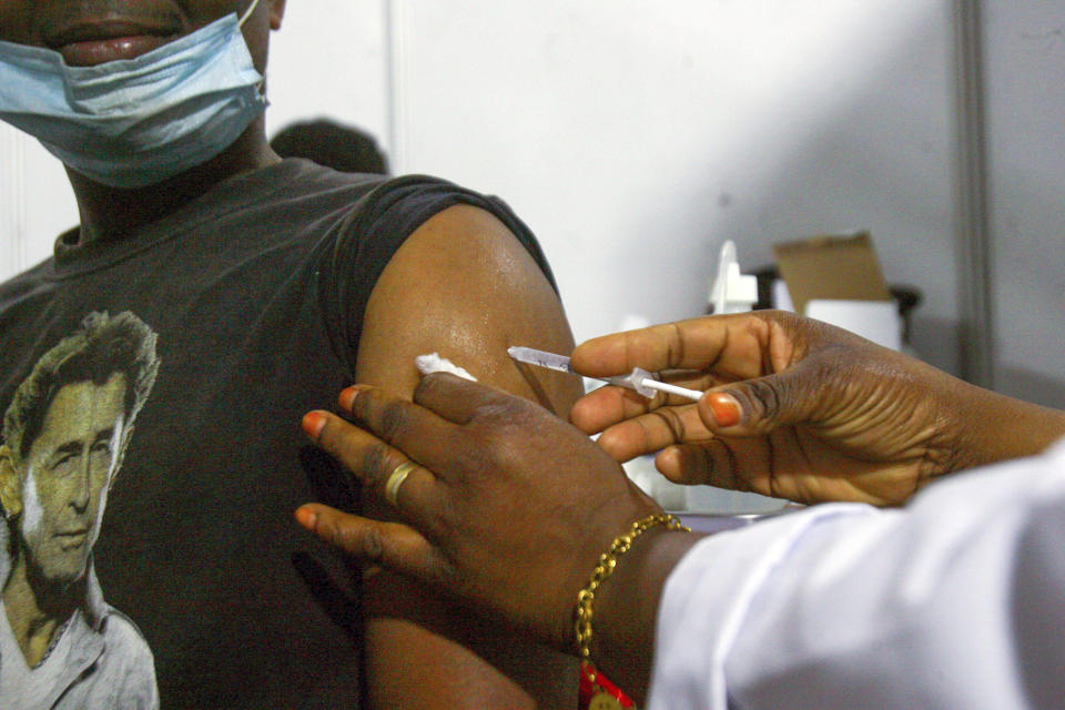 A nurse injects a patient with a dose of AstraZeneca vaccine in Abidjan, Ivory Coast, Friday March 19, 2021. The suspension of the AstraZeneca vaccine in several European countries over the past week could fuel skepticism about the shot far beyond their shores, potentially threatening the rollout of a vaccine that is key to the global strategy to stamp out the coronavirus pandemic, especially in developing nations. (AP Photo/ Diomande Ble Blonde)