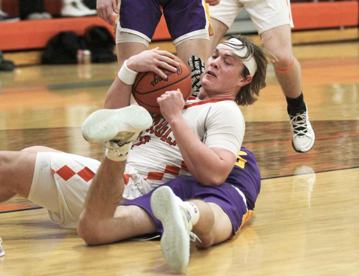 Gibson Cary of Sturgis wins the battle for a loose ball with Boston Bucklin of Bronson on Monday.