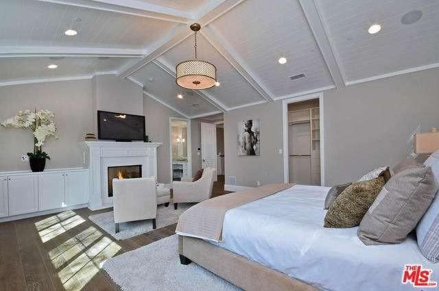 <p>The large master suite has a fireplace, high ceilings and a massive walk-in closet. (Realtor.com) </p>