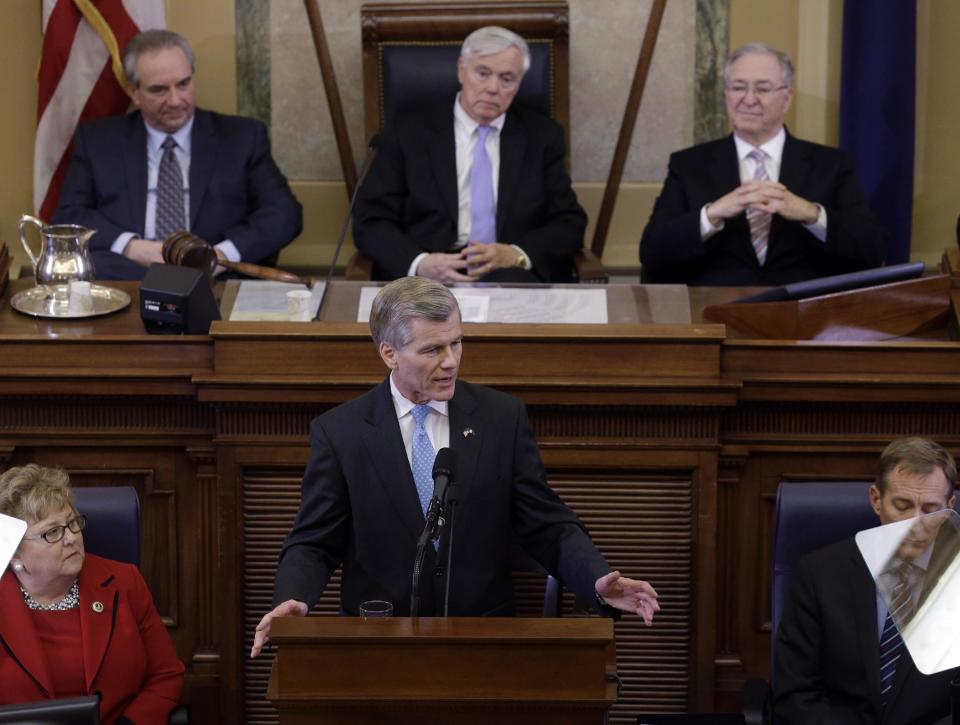 Virginia Gov. Bob McDonnell, at podium, gestures as he delivers his State of the Commonwealth address before a joint session of the 2014 General Assembly at the Capitol in Richmond, Va., Wednesday, Jan. 8, 2014. Lt. Gov. Bill Bolling, top left, House speaker William Howell, R-Stafford, top center, and State Sen. Walter Stosch, R-Henrico, top right, listen. (AP Photo/Steve Helber)