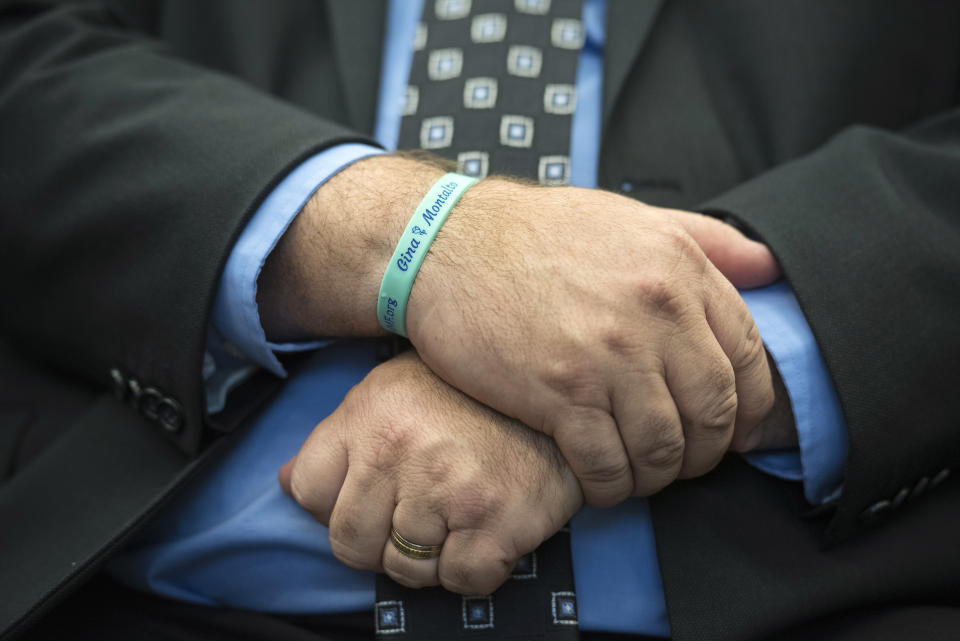 Tony Montalto, whose 14-year-old daughter Gina was killed in the Parkland school mass shooting and who is president of "Stand with Parkland," wears a bracelet with Gina's name during the announcement of the release of the Secret Service National Threat Assessment Center's Protecting America's Schools report, in Washington, Thursday, Nov. 7, 2019. The report examines 41-targeted attacks that occurred in schools between 2008 and 2017. (AP Photo/Cliff Owen)