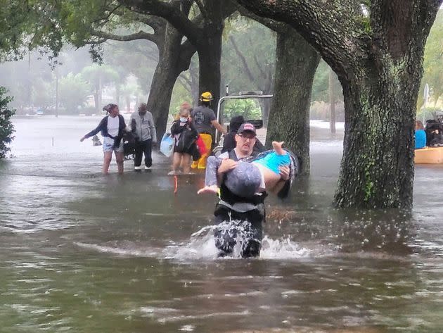 Orange County Fire Rescue's firefighters help people stranded by Hurricane Ian early Thursday. (Photo: Orange County Fire Rescue's Public Information Office via AP)