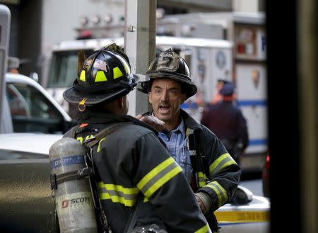 New York City firefighters work on the scene where a building undergoing demolition work partially collapsed, in New York October 30, 2015. REUTERS/Brendan McDermid