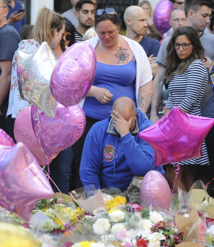 Victim Olivia Campbell’s mum, Charlotte, looks at the floral tributes following the attack (Rex)