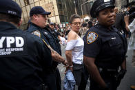 <p>Immigration activists protesting the Trump administration’s decision on the Deferred Action for Childhood Arrivals are arrested by New York City Police (NYPD) officers after they sat in the street and blocked traffic on Fifth Avenue near Trump Tower, Sept. 5, 2017. (Photo: Drew Angerer/Getty Images) </p>