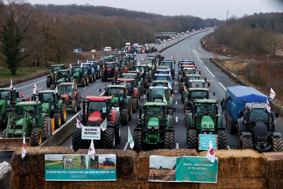 French farmers block a highway in Longvilliers, near Paris, before the EU summit on Thursday (Reuters)