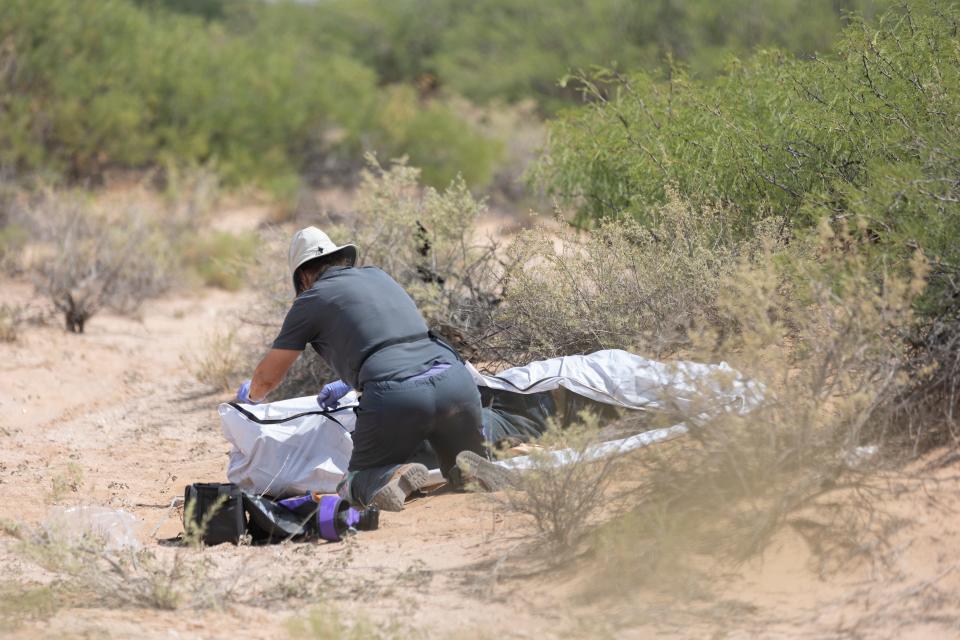 Laura Mae Williams, a field investigator for New Mexico's Office of the Medical Investigator, zips a body bag used to collect the remains of 31-year-old Yenefer Vazque, a migrant found on Aug. 29, 2023 in New Mexico.