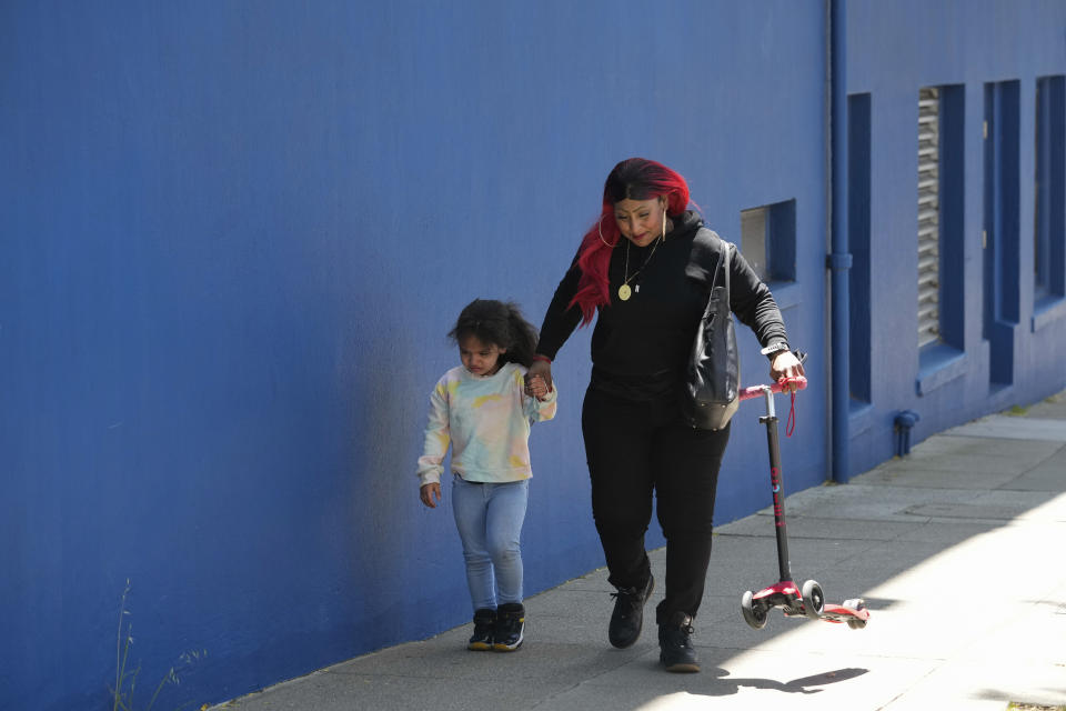 Teniah Tercero, right, walks with her daughter Valentina, 4, after playing with the family's scooter Thursday, May 23, 2024, in San Francisco. (AP Photo/Godofredo A. Vásquez)