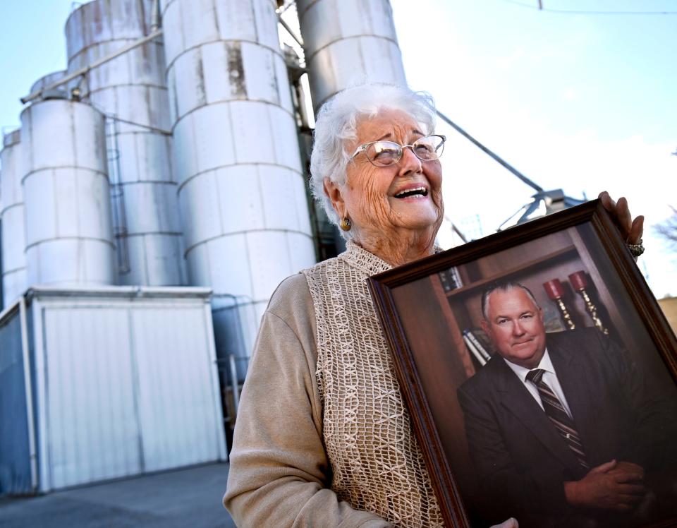 Monteva "Monty" Vinson holds a portrait of her late husband J.W. "Dub" Vinson outside their grain elevator at Abilene Ag Services & Supply Feb. 13. The Vinsons were honored Friday as the Farm Family of the Year.