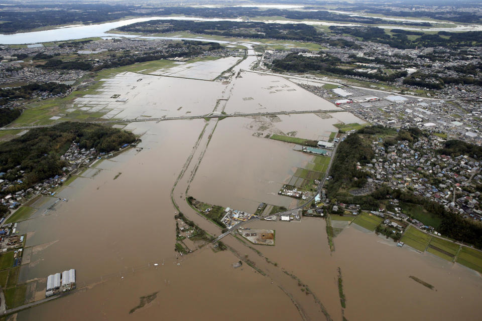 The Kashima River basin is submerged in waters after torrential rain in Sakura city, Chiba prefecture, east of Tokyo, Saturday, Oct. 26, 2019. Torrential rain that caused flooding and mudslides in towns east of Tokyo added damage in areas still recovering from recent typhoons. (Kyodo News via AP)