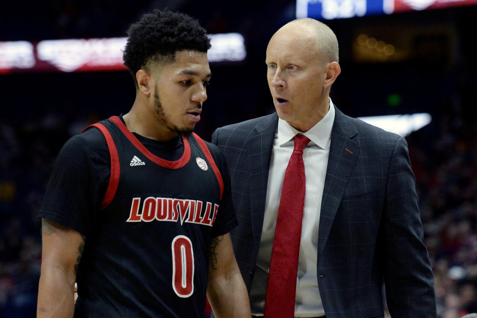 Louisville head coach Chris Mack, right, talks with Louisville guard Lamarr Kimble during the second half of an NCAA college basketball game against Western Kentucky Friday, Nov. 29, 2019, in Nashville, Tenn. (AP Photo/Mark Zaleski)