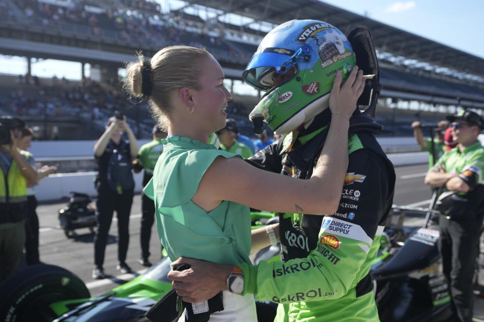 Rinus VeeKay, of The Netherlands, get a hug from his wife, Carmen van Kalmthout, during qualifications for the Indianapolis 500 auto race at Indianapolis Motor Speedway, Saturday, May 18, 2024, in Indianapolis. (AP Photo/Darron Cummings)