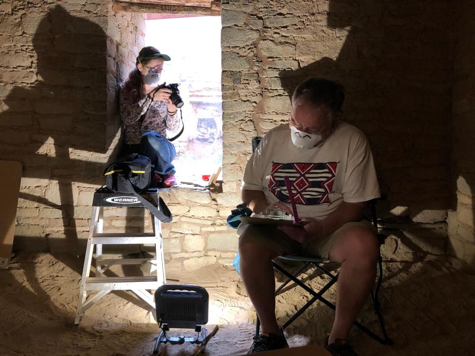 Moriah Sonnenberg and Fred Blackburn document their findings during a survey of historic inscriptions at Aztec Ruins National Monument in 2019.