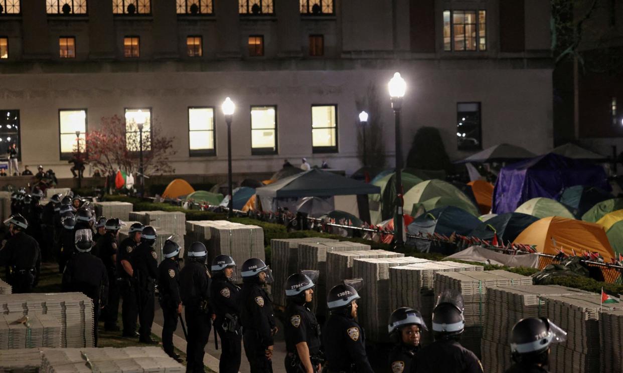 <span>Police stand guard near an encampment of protesters supporting Palestinians on the grounds of Columbia University in New York City on 30 April.</span><span>Photograph: Caitlin Ochs/Reuters</span>
