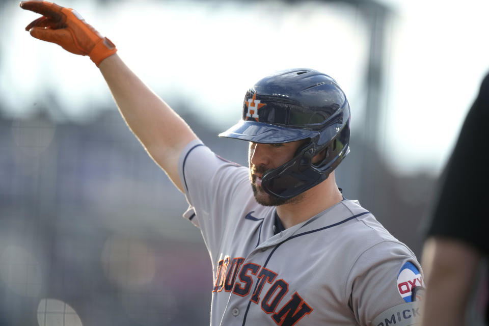 Houston Astros' Chas McCormick gestures to the dugout after his RBI single against the Colorado Rockies during the first inning of a baseball game Tuesday, July 18, 2023, in Denver. (AP Photo/David Zalubowski)