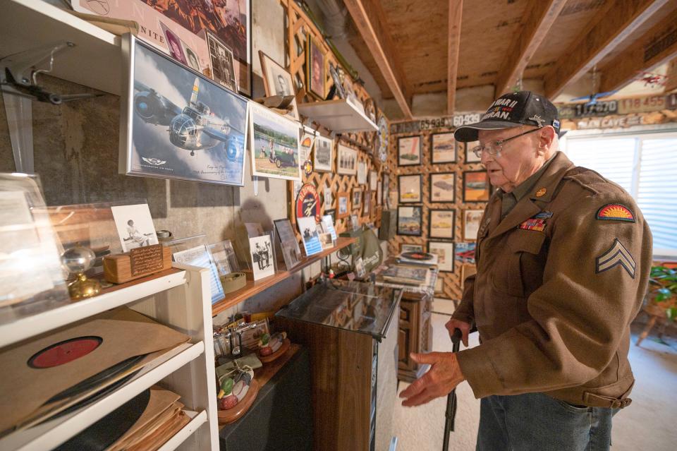 World War II veteran Bruce Elson looks over some of his most prized possessions at his home on Thursday, November 9, 2023.