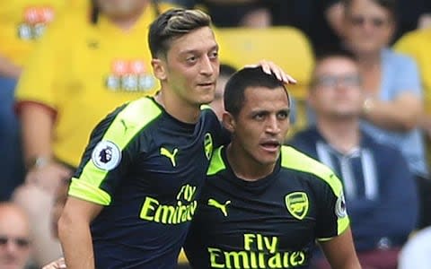 Alexis Sanchez (right) celebrates with team-mate Mesut Ozil  - Credit: Tim Goode/PA Wire