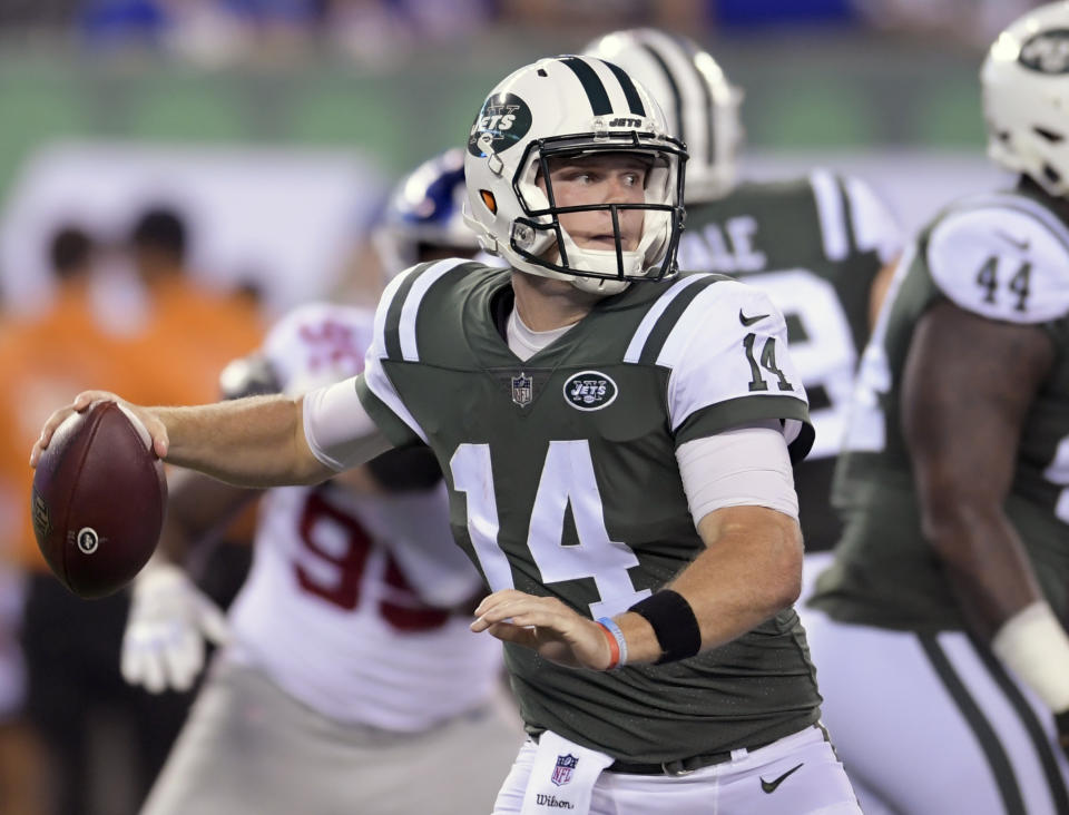 FILE - In this Aug. 24, 2018, file photo, New York Jets quarterback Sam Darnold (14) steps back to throw against the New York Giants during the second quarter of an NFL preseason football game, in East Rutherford, N.J. Darnold will start at quarterback in the New York Jets' season-opening game at Detroit on Monday night. The 21-year-old Darnold will be the youngest quarterback to start in Week 1 since the 1970 NFL-AFL merger. The announcement Monday, Sept. 3, 2018, by coach Todd Bowles comes as no surprise as the rookie was solid while starting the Jets' second and third preseason games.(AP Photo/Bill Kostroun, File)