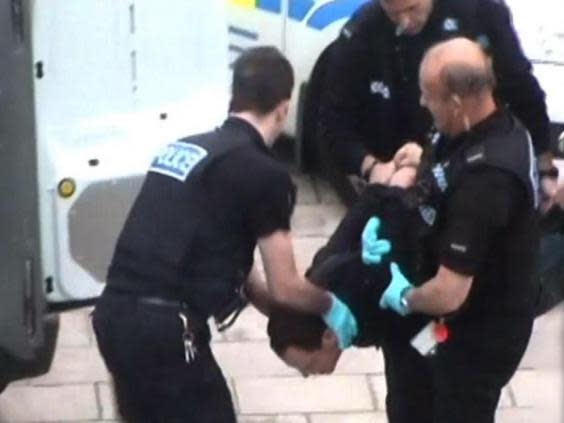 Thomas Orchard is carried into a police van after his arrest in Exeter in 2012