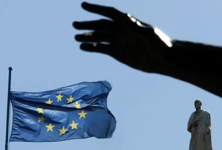 A European Union flag flutters near the hand of a statue on Campidoglio square in central Rome, Italy, March 23 2007. REUTERS/Tony Gentile/Files
