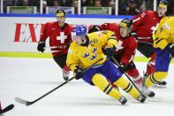 Sweden's Filip Forsberg is chased by Switzerland's Samuel Kreis during their IIHF World Junior Hockey Championship ice hockey game in Malmo December 26, 2013. REUTERS/Ludvig Thunman/TT News Agency (SWEDEN - Tags: SPORT ICE HOCKEY) ATTENTION EDITORS - THIS IMAGE WAS PROVIDED BY A THIRD PARTY. THIS PICTURE IS DISTRIBUTED EXACTLY AS RECEIVED BY REUTERS, AS A SERVICE TO CLIENTS. SWEDEN OUT. NO COMMERCIAL OR EDITORIAL SALES IN SWEDEN. NO COMMERCIAL SALES
