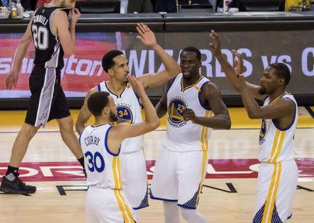 May 14, 2017; Oakland, CA, USA; Golden State Warriors guard Stephen Curry (30) high fives guard Shaun Livingston (34), forward Draymond Green (23) and forward Kevin Durant (35) after a basket against the San Antonio Spurs during the fourth quarter in game one of the Western conference finals of the 2017 NBA Playoffs at Oracle Arena. Mandatory Credit: Kelley L Cox-USA TODAY Sports