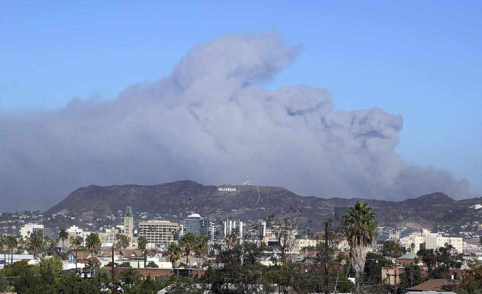 <p>Smoke from the Creek wildfire in the San Gabriel Mountains, the second range behind the Hollywood Hills, home of the Hollywood sign, looms up over Los Angeles Tuesday morning, Dec. 5, 2017. (Photo: Reed Saxon/AP) </p>